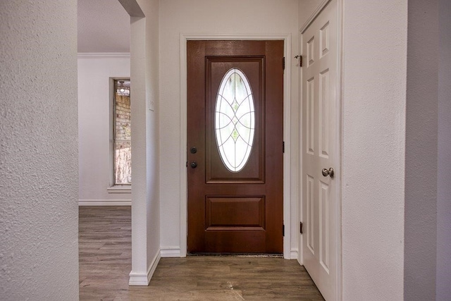 2307 Timber Ridge Dr, Portland, TX 78374 - entrance foyer featuring arched walkways, wood finished floors, a textured wall, and ornamental molding