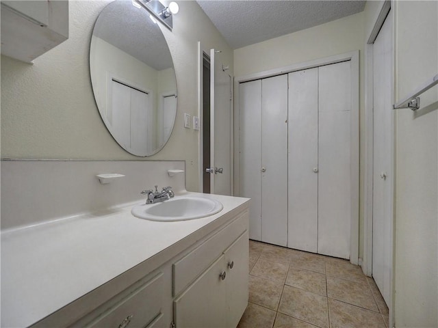 1638 Spicewood Dr, Corpus Christi, TX 78412 - bathroom with vanity, tile patterned floors, and a textured ceiling