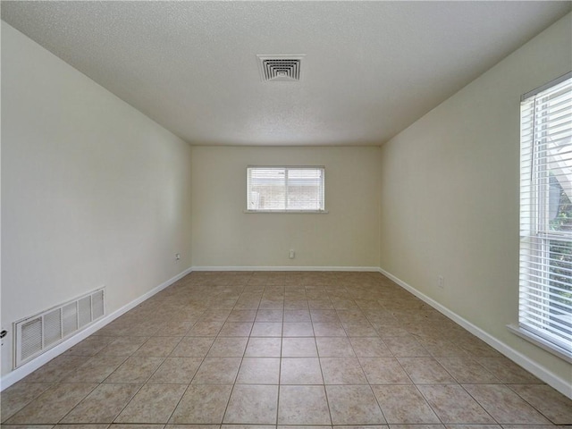 1638 Spicewood Dr, Corpus Christi, TX 78412 - unfurnished room with light tile patterned flooring and a textured ceiling