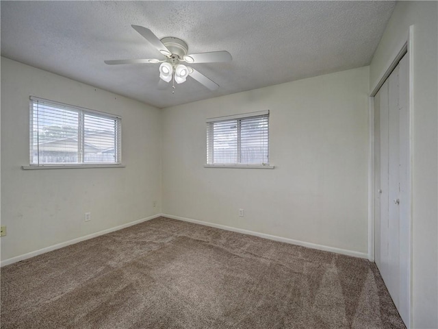 1638 Spicewood Dr, Corpus Christi, TX 78412 - unfurnished bedroom with multiple windows, carpet, a closet, and a textured ceiling
