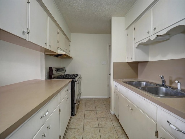 1638 Spicewood Dr, Corpus Christi, TX 78412 - kitchen featuring stainless steel gas range oven, a textured ceiling, under cabinet range hood, light countertops, and white cabinetry