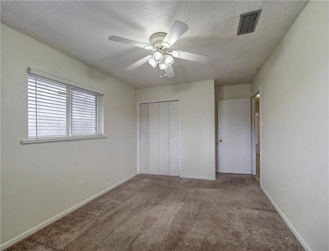 1638 Spicewood Dr, Corpus Christi, TX 78412 - unfurnished bedroom with carpet, a textured ceiling, a closet, and a ceiling fan