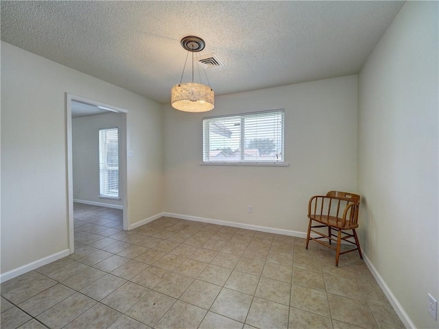 1638 Spicewood Dr, Corpus Christi, TX 78412 - empty room with healthy amount of natural light, a textured ceiling, and light tile patterned flooring