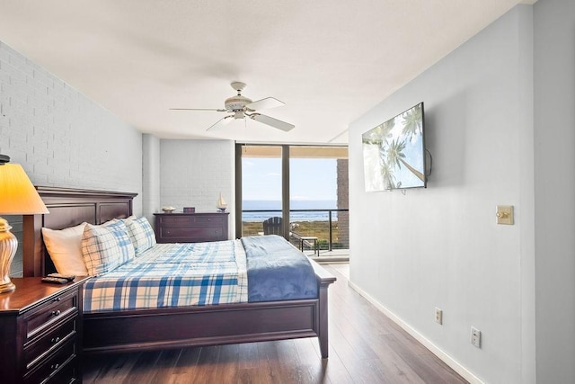 bedroom with access to outside, dark hardwood / wood-style floors, ceiling fan, and a wall of windows