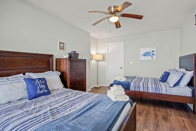 bedroom with ceiling fan and dark hardwood / wood-style flooring