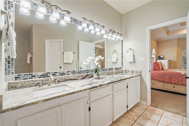 7526 Milan St, Corpus Christi, TX 78414 - ensuite bathroom featuring double vanity, marble look tile flooring, and crown molding