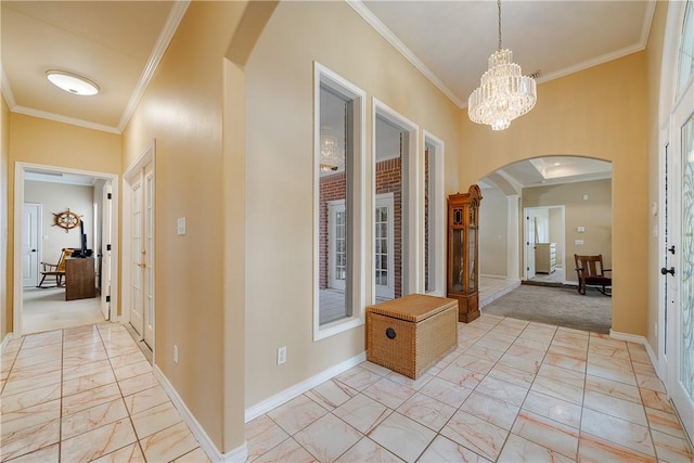 7526 Milan St, Corpus Christi, TX 78414 - corridor with arched walkways, light marble finish flooring, ornamental molding, a chandelier, and light carpet