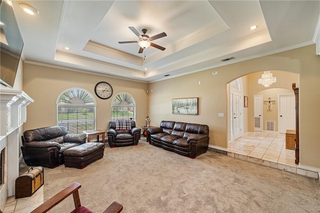 7526 Milan St, Corpus Christi, TX 78414 - carpeted living room featuring arched walkways, a premium fireplace, a tray ceiling, ceiling fan, and crown molding