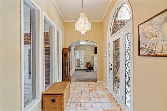 7526 Milan St, Corpus Christi, TX 78414 - foyer with arched walkways, light marble finish floors, a chandelier, and ornamental molding
