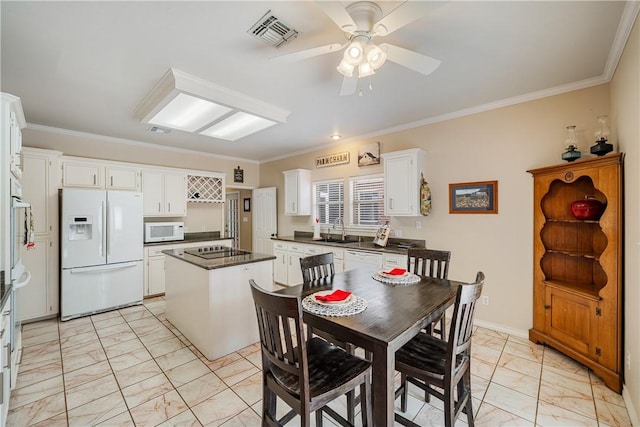 7526 Milan St, Corpus Christi, TX 78414 - dining space featuring light marble finish floors, crown molding, and ceiling fan