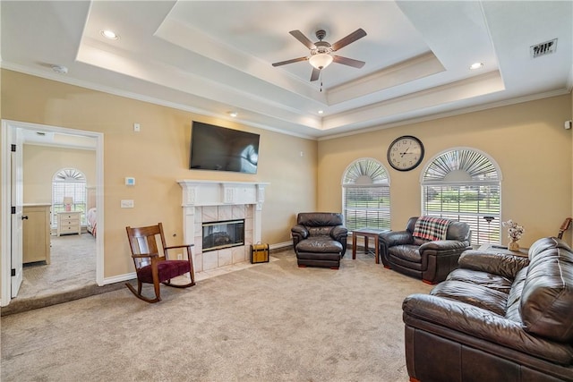 7526 Milan St, Corpus Christi, TX 78414 - living room featuring a tray ceiling, carpet flooring, a ceiling fan, ornamental molding, and plenty of natural light