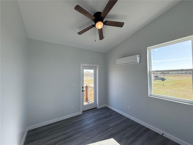 empty room with an AC wall unit, dark wood-type flooring, ceiling fan, and vaulted ceiling