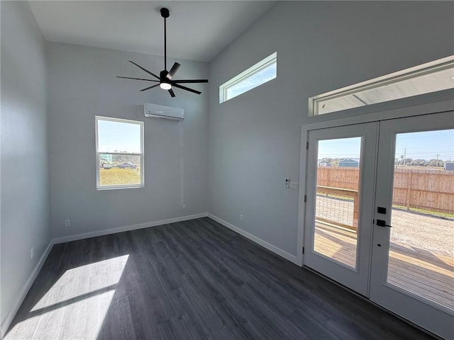 empty room featuring a high ceiling, dark wood-type flooring, french doors, ceiling fan, and a wall mounted air conditioner