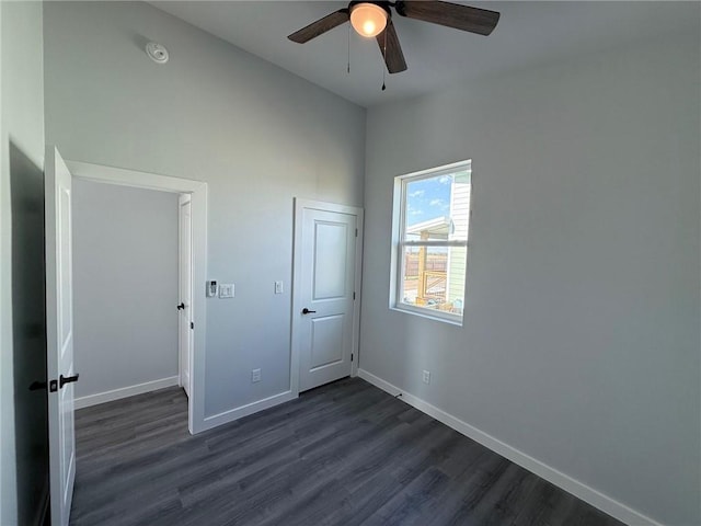 unfurnished bedroom with ceiling fan and dark hardwood / wood-style floors