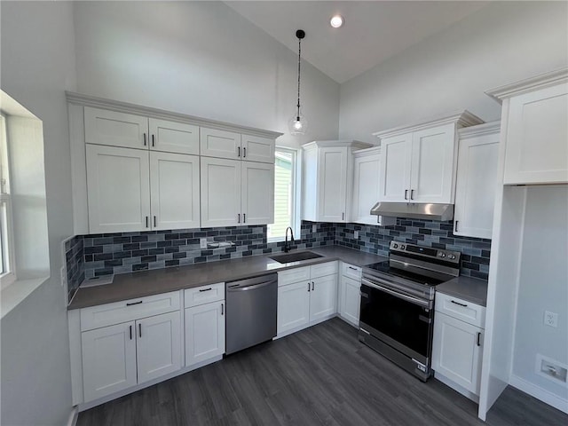 kitchen featuring sink, stainless steel appliances, white cabinetry, and high vaulted ceiling