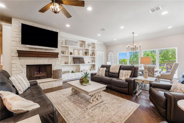 8102 Nazareth Dr, Corpus Christi, TX 78413 - living area with ceiling fan, a stone fireplace, a chandelier, dark wood-style floors, and recessed lighting