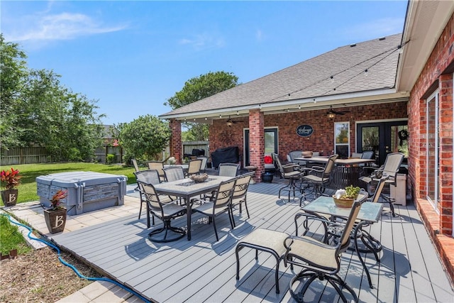 8102 Nazareth Dr, Corpus Christi, TX 78413 - deck with outdoor dining space, a hot tub, a fenced backyard, and ceiling fan