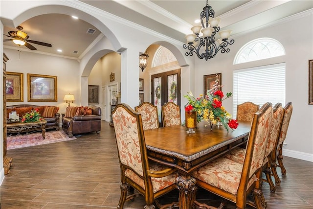 8102 Nazareth Dr, Corpus Christi, TX 78413 - dining space featuring a chandelier, a ceiling fan, arched walkways, crown molding, and baseboards