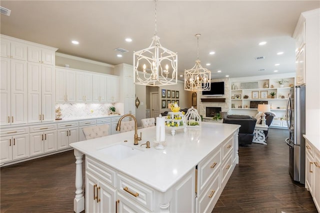 8102 Nazareth Dr, Corpus Christi, TX 78413 - kitchen featuring a sink, freestanding refrigerator, open floor plan, a chandelier, and white cabinets
