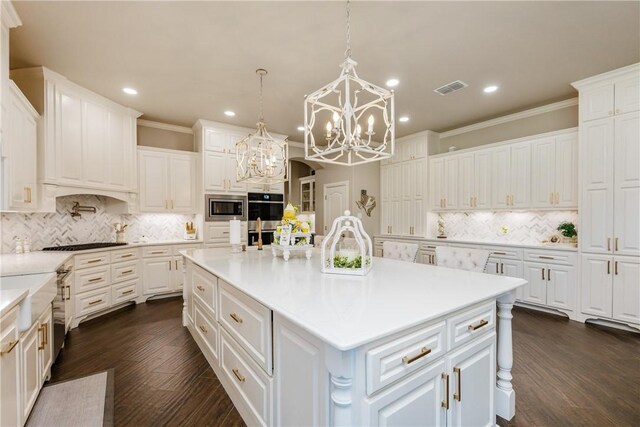 8102 Nazareth Dr, Corpus Christi, TX 78413 - kitchen featuring appliances with stainless steel finishes, a chandelier, decorative backsplash, white cabinetry, and recessed lighting