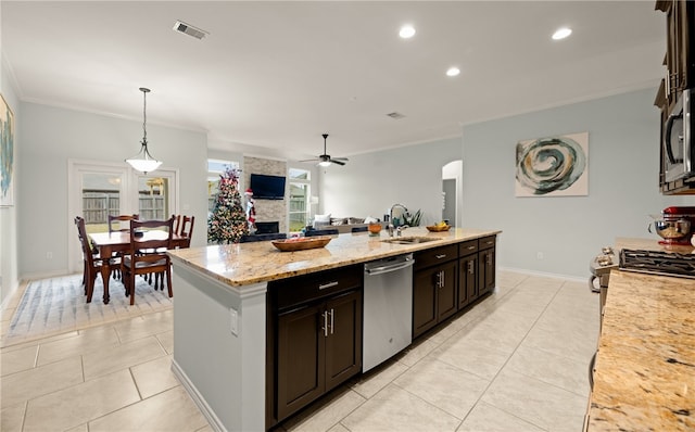 kitchen featuring ceiling fan, sink, decorative light fixtures, a center island with sink, and appliances with stainless steel finishes