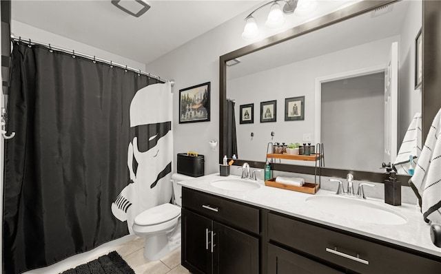 bathroom featuring tile patterned flooring, vanity, and toilet