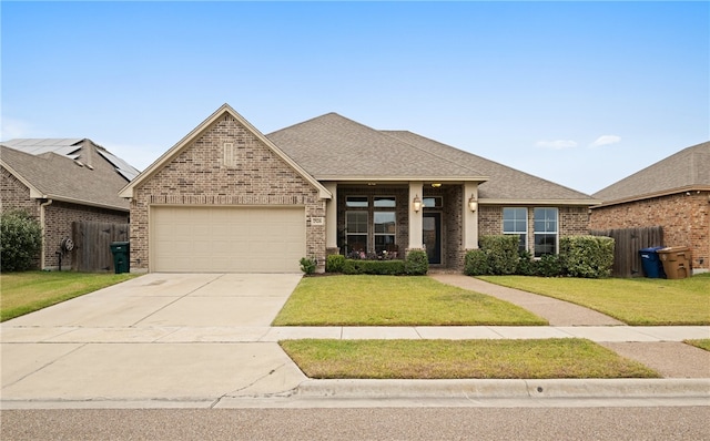 view of front of house featuring a garage and a front lawn