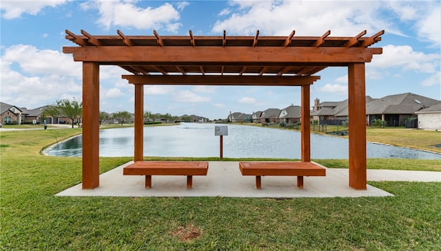 view of property's community featuring a lawn and a water view