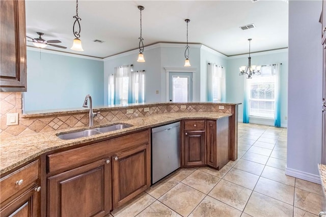 kitchen featuring light stone counters, pendant lighting, visible vents, stainless steel dishwasher, and a sink