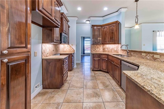 kitchen featuring appliances with stainless steel finishes, light stone counters, ornamental molding, hanging light fixtures, and a sink