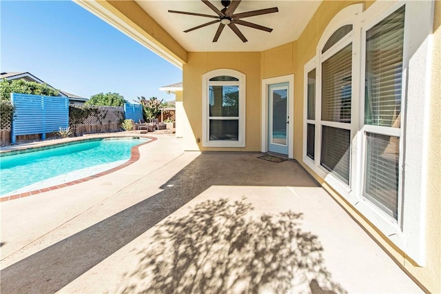 exterior space with a ceiling fan, fence, and a fenced in pool