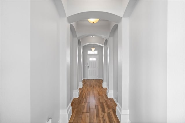 2101 Spoonbill Dr, Corpus Christi, TX 78414 - hallway featuring arched walkways, baseboards, and dark wood finished floors