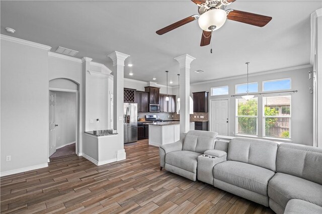 2101 Spoonbill Dr, Corpus Christi, TX 78414 - living room featuring ornamental molding, ornate columns, ceiling fan, wood finished floors, and baseboards