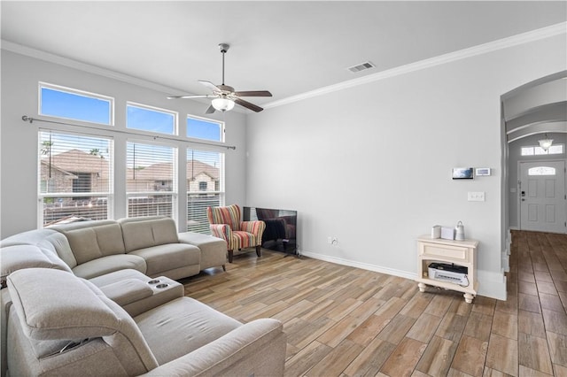2101 Spoonbill Dr, Corpus Christi, TX 78414 - living room featuring arched walkways, ceiling fan, ornamental molding, wood finished floors, and baseboards
