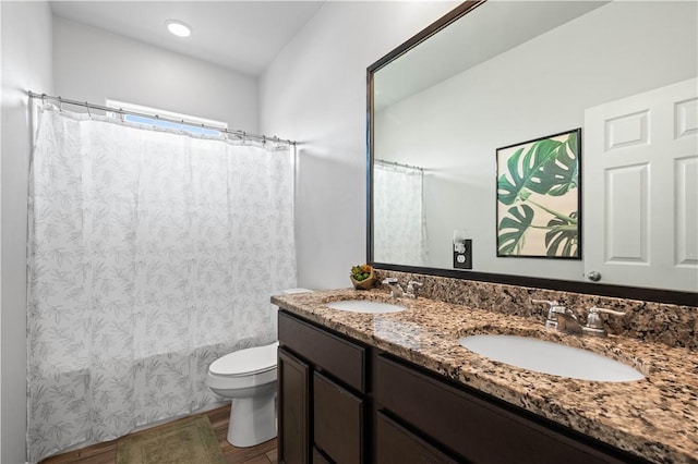 2101 Spoonbill Dr, Corpus Christi, TX 78414 - bathroom with toilet, double vanity, wood finished floors, and shower / bath combo with shower curtain
