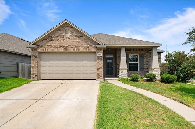 2101 Spoonbill Dr, Corpus Christi, TX 78414 - view of front of house featuring concrete driveway, an attached garage, brick siding, and a front yard