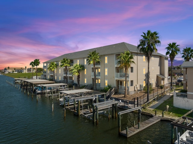 view of dock featuring a water view and a balcony