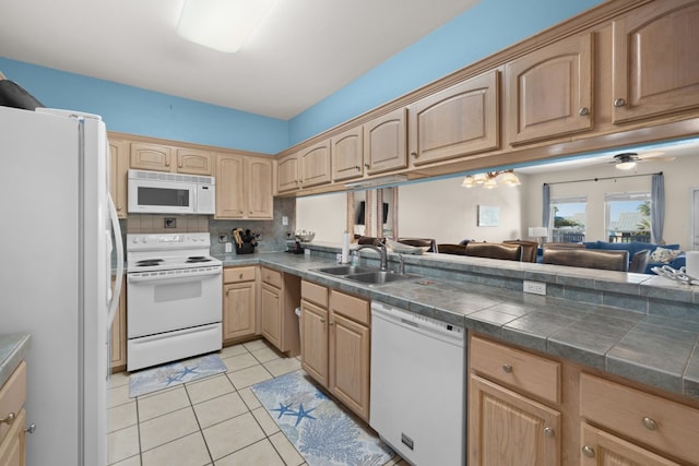 kitchen with sink, tasteful backsplash, ceiling fan with notable chandelier, light tile patterned floors, and white appliances