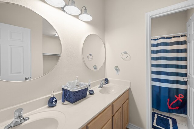 bathroom featuring tile patterned flooring, vanity, and a shower with shower curtain