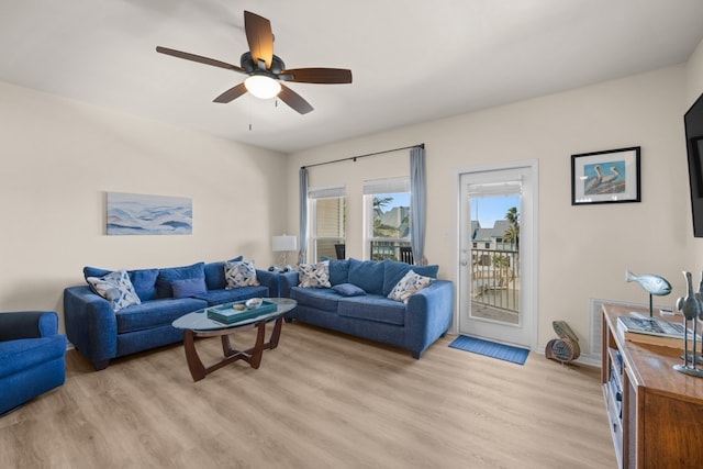 living room featuring light hardwood / wood-style floors and ceiling fan