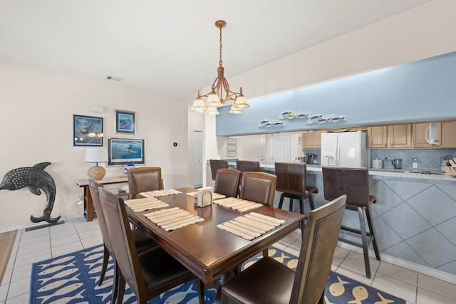 tiled dining area with a notable chandelier