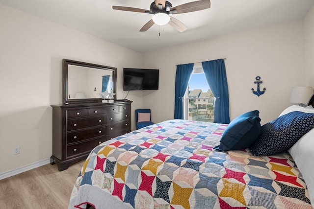 bedroom with light wood-type flooring and ceiling fan