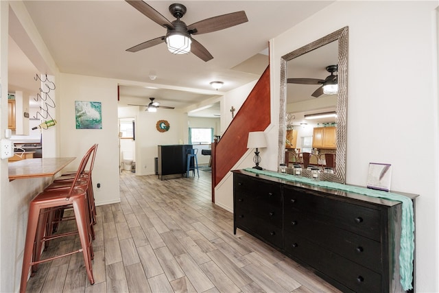 kitchen with light wood-type flooring and ceiling fan