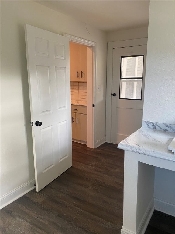 corridor with dark wood-type flooring