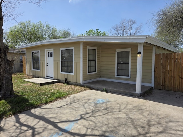 view of front facade with board and batten siding and fence