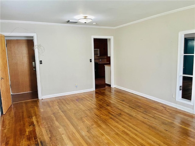 912 E Fulton St, Sinton, TX 78387 - unfurnished room featuring wood finished floors, baseboards, and crown molding
