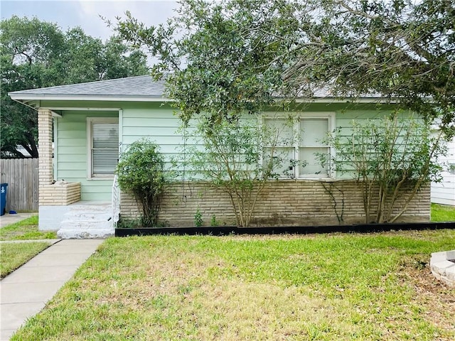 912 E Fulton St, Sinton, TX 78387 - view of side of property with brick siding and a shingled roof