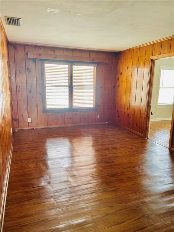 912 E Fulton St, Sinton, TX 78387 - unfurnished room featuring wood finished floors, baseboards, and wooden walls