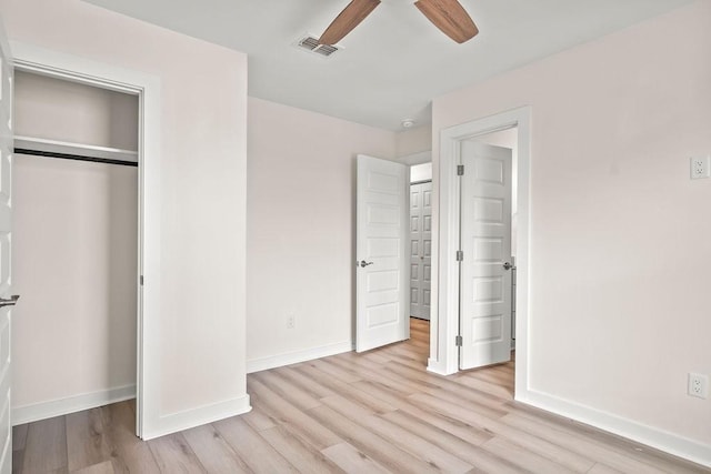 unfurnished bedroom with ceiling fan, a closet, and light hardwood / wood-style flooring