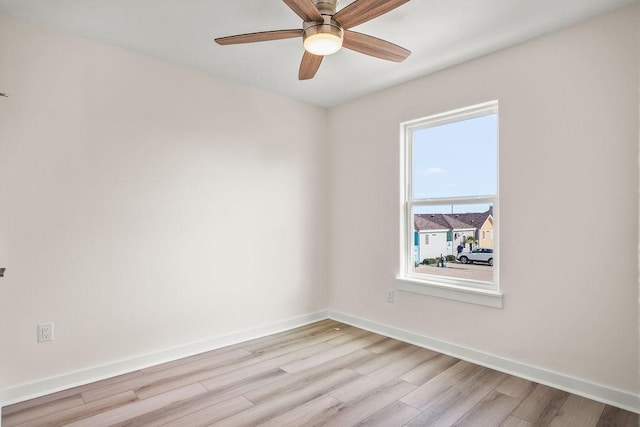 empty room featuring ceiling fan and light hardwood / wood-style flooring